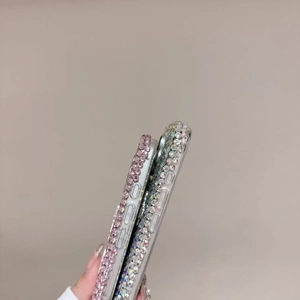 Detail view of iPhone case side edges featuring hand-set pink and silver luxury rhinestones