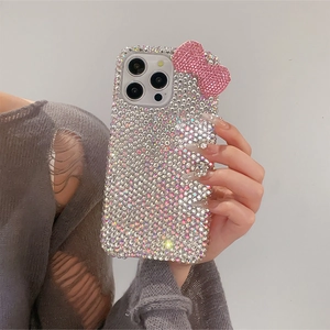 Detailed view of silver rhinestones and 3D pink glitter bow on iPhone luxury case