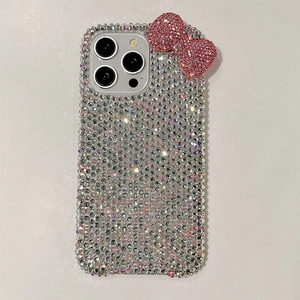 Macro shot of luxury iPhone case featuring full rhinestone inlay and pink crystal bow detail