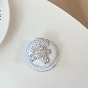 Macro shot of bear phone grip with colorful AB rhinestones and soft white faux fur trim