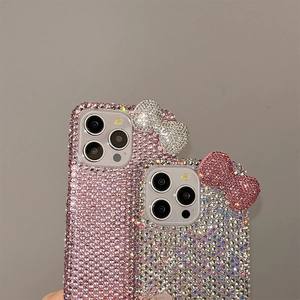 Close-up of luxury rhinestones and 3D bowknot details on stylish iPhone cases