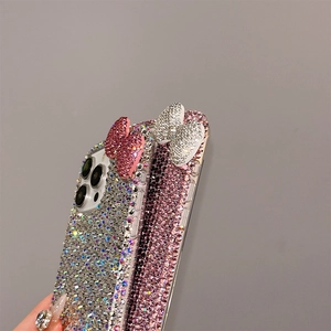 Close-up of luxury sparkling rhinestone bow design on iPhone protective cases