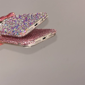 Detail view of precise charging port and speakers on rhinestone bow iPhone case