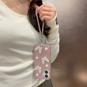 Pink rhinestone phone case with white pearl butterflies and matching wrist strap detail