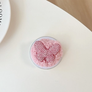 Macro shot of luxury pink rhinestone butterfly phone socket with soft plush backing