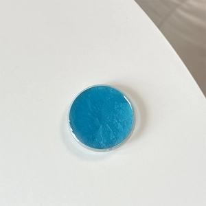 Close-up of deep blue phone socket grip showing textured crinkle surface on white base