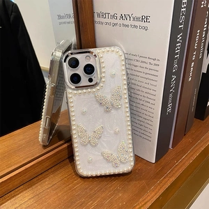 Detail of iPhone case with pearly frame, sparkling glitter, and 3D rhinestone butterflies