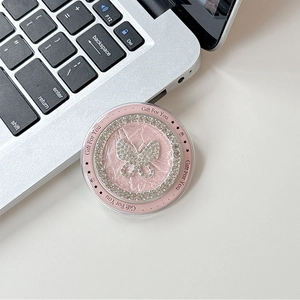 Macro view of pink leather phone grip featuring a sparkling rhinestone butterfly and Gift For You text