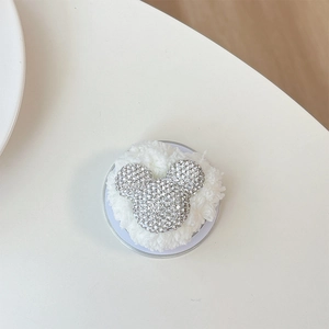 Detail of Mickey-shaped phone grip with sparkling white rhinestones and plush white fur