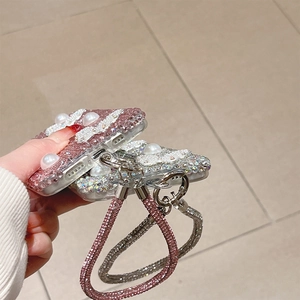 Detail of rhinestone and pearl butterfly phone case with luxury detachable hand strap