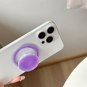 Violet shell texture MagSafe phone grip on white smartphone with marbling design