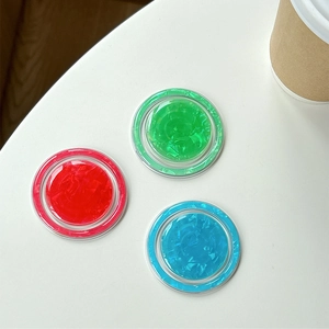Detail of round MagSafe phone grips with colorful ice crack textures in red, green and blue