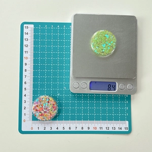 Macro view of round resin phone sockets with colorful heart sequins showing weight measurement