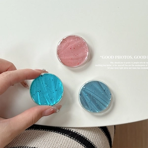 Detail showing round phone sockets with silver foil glitter in pink and blue shades