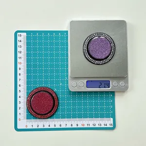 Macro shot showing circular glitter phone grip with rhinestones on a scale for 21.4g weight