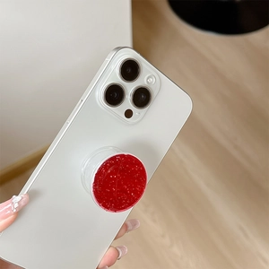 Sparkling red glitter phone grip stand with silver foil texture on white smartphone