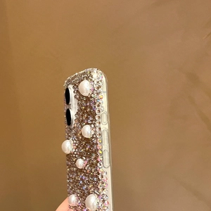 Vue détaillée de la coque de luxe avec strass et perles pour iPhone avec pompon