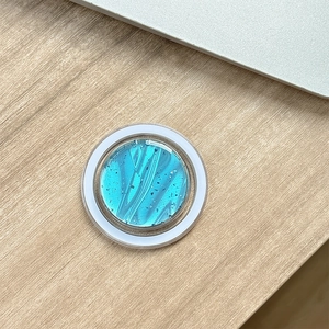 Dettaglio del supporto MagSafe magnetico con texture marmo blu e scaglie d'argento