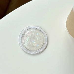 Macro view of shell-patterned MagSafe phone grip with iridescent pearly texture