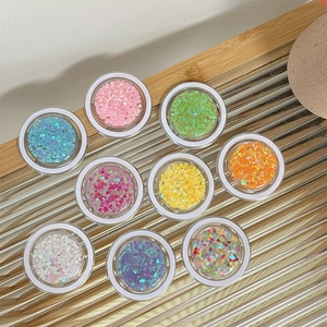 Colorful heart sequins for DIY nail art in 9 round jars on metallic wave display stand