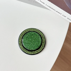Macro view of green glitter MagSafe ring holder with double rhinestone borders