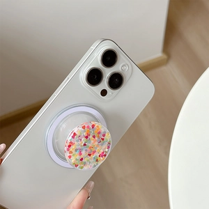 Detail of colorful glitter heart magnetic phone socket on white smartphone case