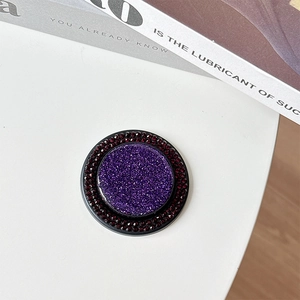 Detail of purple glitter MagSafe phone grip with double rows of red rhinestones