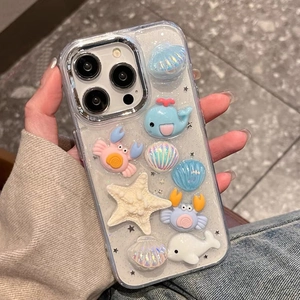 Detail view of iPhone case with glitter finish and 3D resin ocean creature charms