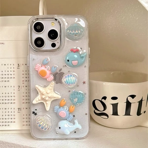 Detail of glitter iPhone case featuring 3D resin ocean animals like whales and crabs