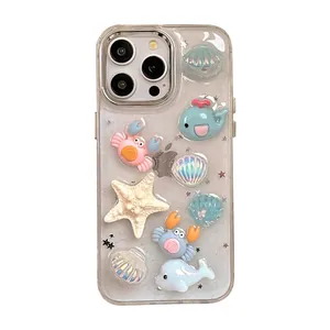 Cute ocean themed iPhone case with 3D glitter whales, crabs and seashells on white background