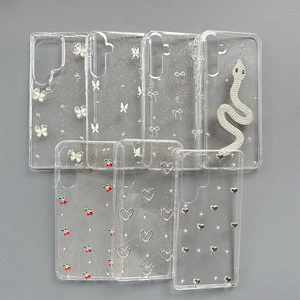 Glitter transparent Samsung S25 case with crystal butterfly, snake and cherry charms