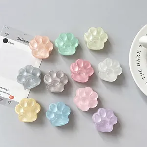 Set of 10 cat paw phone sockets in pastel colors with 3D heart detail on a grey background