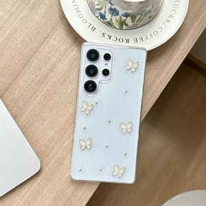 Detail showing 3D white butterfly and silver beads on glittery Samsung S23 Ultra case