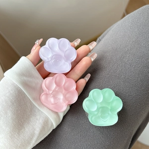 Cute 3D cat paw phone socket grips in pastel lavender pink and mint with heart relief