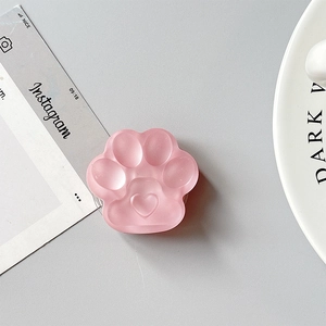 Macro shot of 3D pink cat paw phone grip with matte translucent resin finish