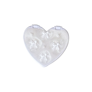 Sparkly heart-shaped makeup mirror with white bows and pearl accents for desktop