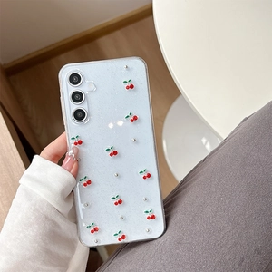Detailed view of clear glitter phone case with 3D red cherry and pearl decorations