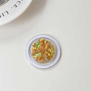 Macro detail of butterfly laser sequins in a clear round jar with golden iridescent finish