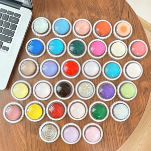 Colorful MagSafe phone grips in multiple vibrant shades on a wooden desk background