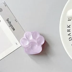 Detail view of a 3D purple cat paw phone socket holder with a matte heart center design