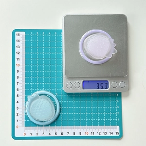 Detailed view of translucent strawberry silicone rings on a digital scale for size reference