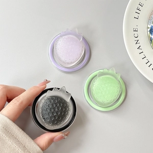 Detail of 3D strawberry magnetic phone holders in purple, green and transparent black