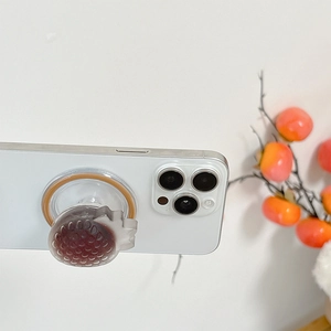 3D strawberry MagSafe phone grip with realistic deep red texture on a white smartphone