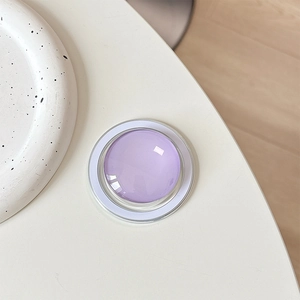 Macro view of a purple crystal glass Magsafe phone grip with a jelly texture design