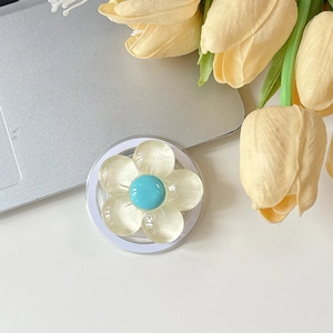 Détail du support téléphone fleur jaune avec perle bleue sur base acrylique