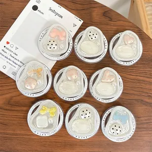 Magnetic cream-colored phone socket set with pearls and bows on wood background