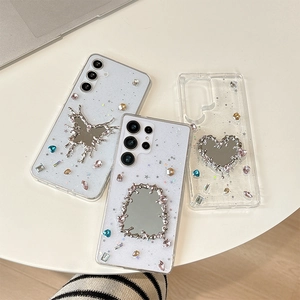 Detailed view of clear glitter cases with luxury rhinestones and large metal mirrors