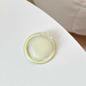 Detail of 3D strawberry MagSafe phone grip with textured surface and transparent base