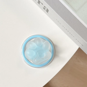 Detail of light blue translucent cat paw phone grip with heart patterns on a white background
