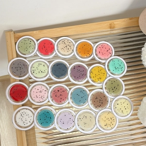Set of 24 colorful glitter Magsafe phone grips in a stylish striped glass tray